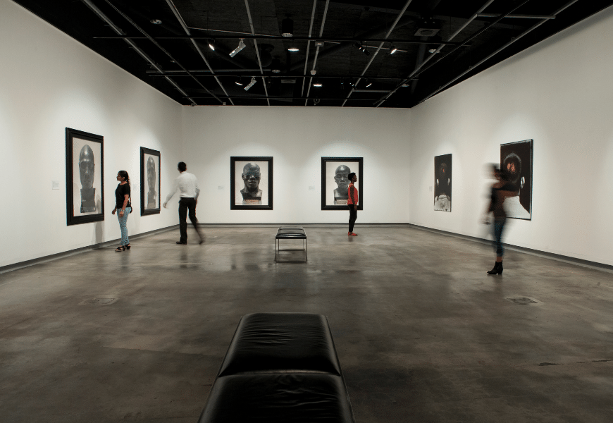Visitors looking at artworks inside Griffith University Art Museum