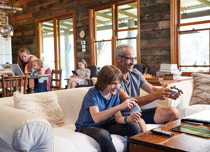 grandad and grandson playing video games at home