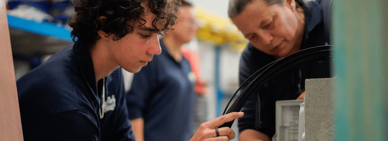 Experienced nbn field technician training a younger member of the team