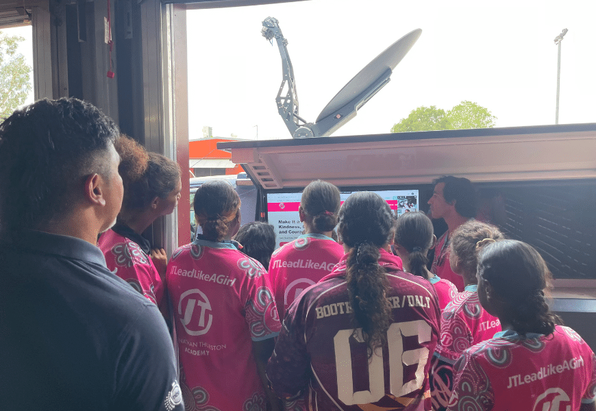 Che Cockatoo-Collins looks on as Johnathan Thurston talks with JTLeadLikeAGirl program members